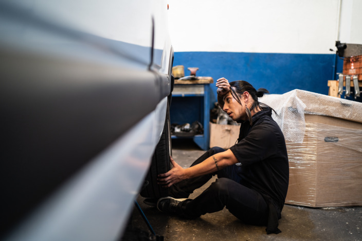 Mann erschöpft in Autowerkstatt