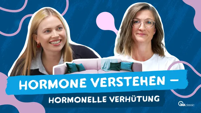 Foto zweier Frauen mit einer rosanen Couch in der Mitte