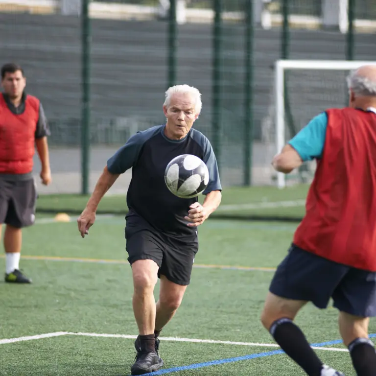 Ältere Männer beim Fußballspielen auf dem Fußballplatz