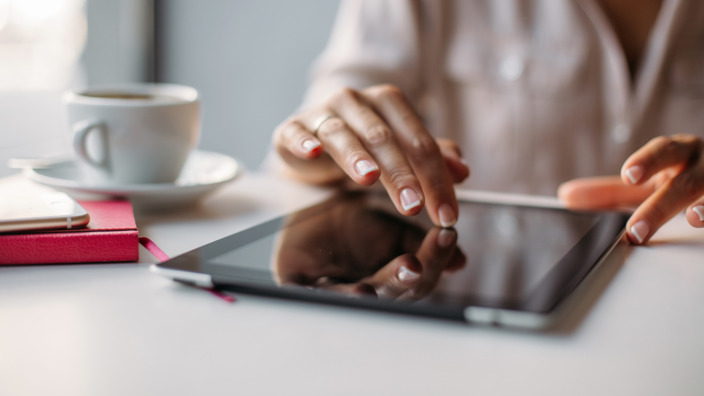 Frau lädt ein Formular auf ihrem Tablet herunter